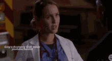 a female doctor with a stethoscope around her neck is talking to a man in an ambulance .