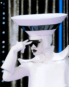 a person in a white costume with a bowl on their head and sunglasses on