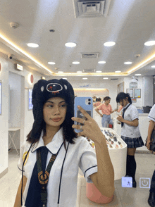 a girl in a school uniform is taking a picture of herself in a mirror