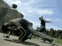 a person wearing a mask is doing a handstand on a concrete surface