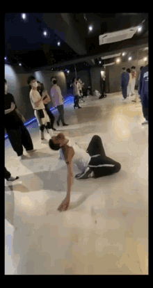 a group of people are dancing in a dance studio and one of them is wearing a shirt that says ' chicago ' on it
