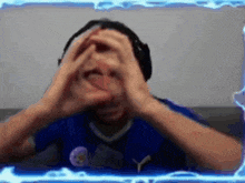 a man wearing headphones is making a heart shape with his hands