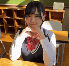 a girl making a heart shape with her hands