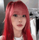 a woman with red hair is taking a selfie in front of a mirror .