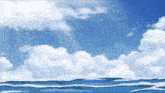 a blue sky with white clouds and a body of water in the foreground