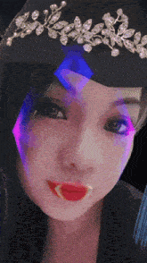 a close up of a woman wearing a black hat with a tiara on her head