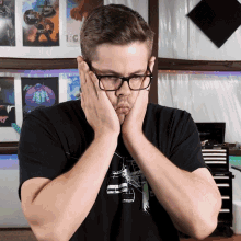 a man wearing glasses and a black shirt with a picture of a monkey on it
