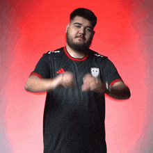 a man with a beard wearing an adidas shirt