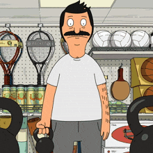 a man holding a kettlebell in front of a rack that says racket