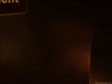 a man in a suit and tie is standing in front of a door
