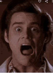 a close up of a man 's face with a surprised look on his face