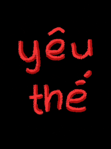 a black background with red letters that say yêu the