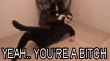 a man in a cat costume is laying on the floor with the words `` yeah , you 're a bitch '' .