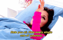 a woman laying in bed with the words hate you all