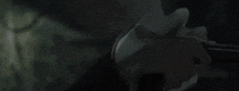 a person is laying on the ground with their hands up in the air .