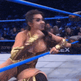 a woman in a wrestling ring with a tmw logo in the background