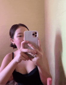 a woman is taking a selfie with her phone