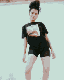 a woman wearing a black t-shirt with a picture of a person on it