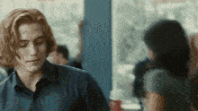 a man with red hair is looking at a woman