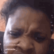 a close up of a person 's face with a slight wrinkle in the forehead .