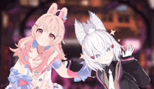 a girl with bunny ears is standing next to a boy with a cat on his head
