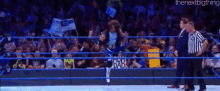 a man in a wrestling ring is holding a sign that says i 'm your dad .