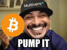 a man wearing a hat that says multivers holds up a bitcoin