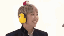 two men wearing headphones and a hat are making funny faces .