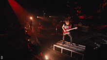a man playing a guitar with a shirt that says " obey " on it