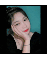 a girl with red lipstick and a black shirt holds her hand to her face