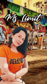 a woman wearing an orange shirt with eagle on it