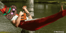 a man laying in a hammock playing a guitar with a koala on his head