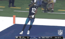 a football player with the number 12 on his jersey is jumping in the air