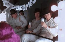 a group of men are drinking milk in front of a sign that says ' echeme '