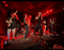 a group of people playing instruments on a stage in front of a sign that says ' aida ' on it