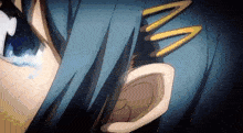 a close up of a person 's ear with a blue hair clip in it