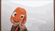 a person is drawing a cartoon character on a piece of paper