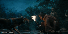 a man is holding a torch in the dark and the hashtag pranav_varma is visible