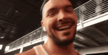 a man with a beard is smiling and looking at the camera .