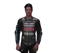 a man in a petronas sprinta yamaha jacket stands in front of a white background