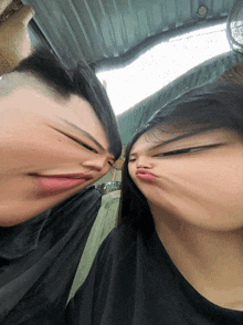 a man and a woman are making funny faces with their mouths