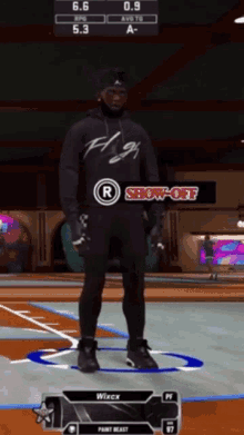 a man is standing on a basketball court wearing a hoodie that says fly