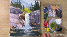 a painting of a waterfall next to a palette with the words made in animatica on it