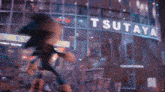 a blurred image of a building with a sign that says ' tsutaya ' on it
