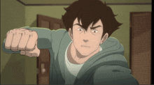 a man in a green hoodie is pointing his fist at the camera