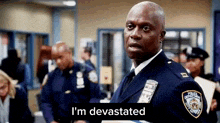 a police officer is standing in front of a group of police officers in a room .