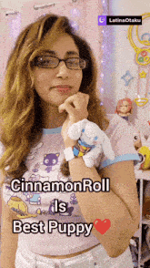 a woman holding a stuffed animal with the words cinnamon roll is best puppy