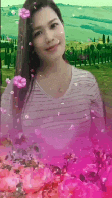 a woman in a striped shirt is surrounded by flowers