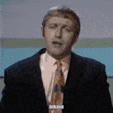 a man in a suit and tie says johann in front of a blue background