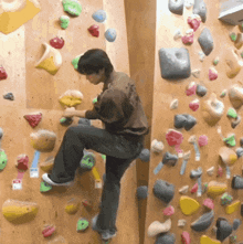 a man is climbing a climbing wall with a sticker on it that says ' a '